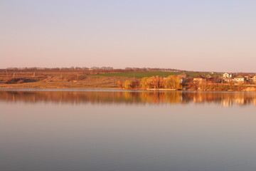 A body of water with trees in the background