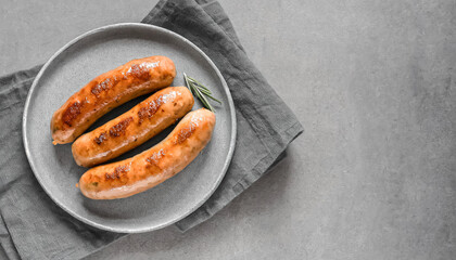 grilled sausage. top view of grilled sausage on grey plate, copy space
