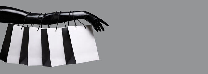 Shopping fastival concept. Shopping bags attached to the arm of a mannequin. 