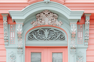 Close view of a Victorian door surround with millwork and a transom window against a blush pink background - obrazy, fototapety, plakaty