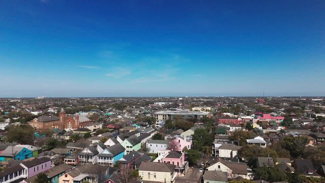 Drone flying over Faubourg Marigny neighborhood on a sunny day with blue sky in New Orleans