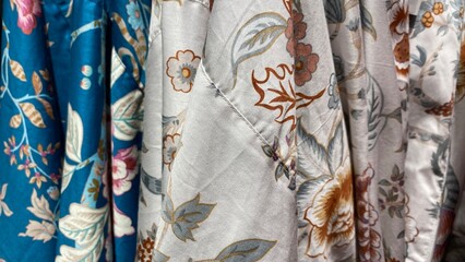 Home clothes. Textile. Floral oriental pattern on fabric. Silk robe in different colors