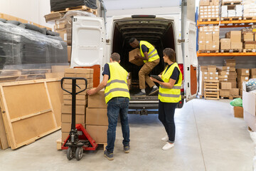 Teamwork At Warehouse. Unloading Delivery Van.