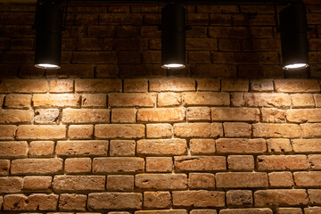 Brick wall illuminated by lamps