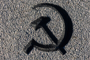 Volumetric Iconic Hammer and Sickle Symbol on a granite Surface