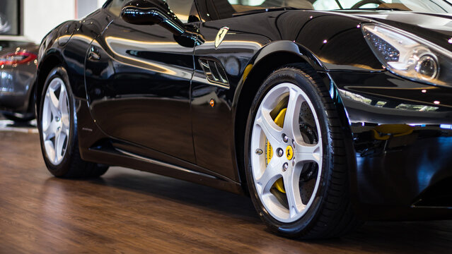Black Ferrari California side view in showroom - High Resolution Image