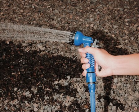 A Hand Holding A Garden Hose