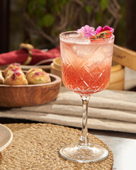 peach summer drink with food in the background soothing scene