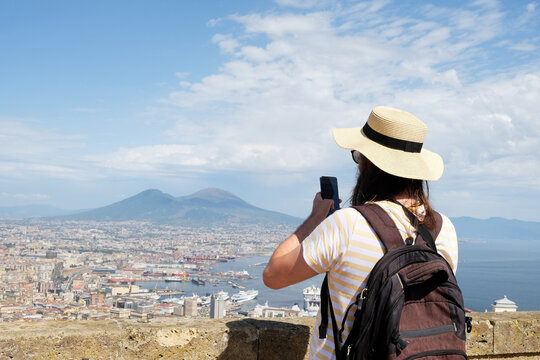 Male tourist taking photos of Naples city From Castle Saint Elmo