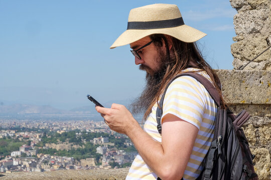 Male tourist using mobile phone while standing at Castel Saint Elmo