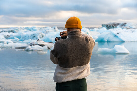 Capturing melting glacier pieces floating in icy water lagoon