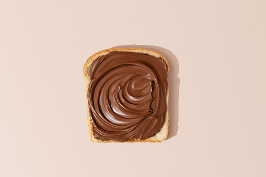 Slice of Fresh Bread On A Light Brown Background Overhead