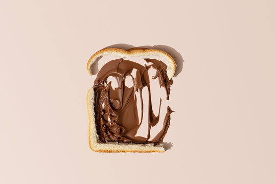 Slice of Fresh Bread On A Light Brown Background Overhead