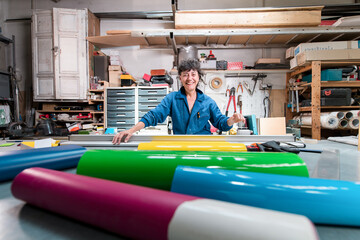 Smiling senior worker at print shop workshop