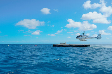 Helicopter landing at Great Reef for joy flight over the reef