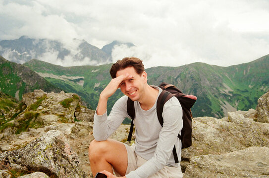 portrait  a man tourist sits on the top of the Tatra, Poland