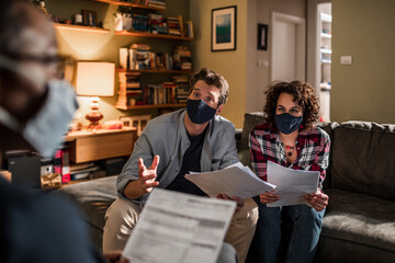 Couple talking about financials to advisor at home