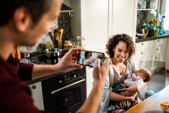 New parents with their baby at the dining table
