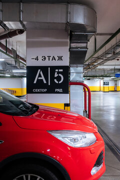 A red car in the underground parking lot.