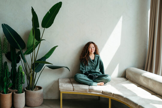 Smilnig female with prosthetic arm at home.
