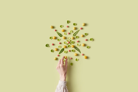 Female hand completing composition made of fruits and plants