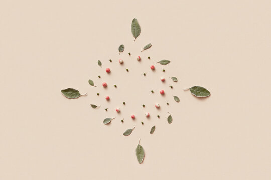 Rhombus shape arranged from sage leaves, buds and paradise apples