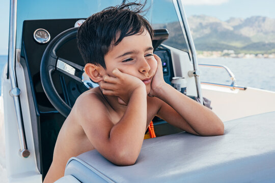 Bored kid in a small yacht