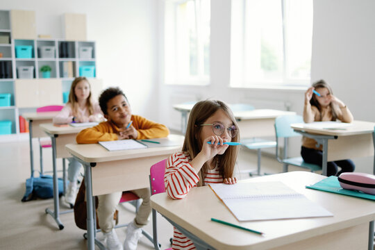 School students listening tutor in classroom