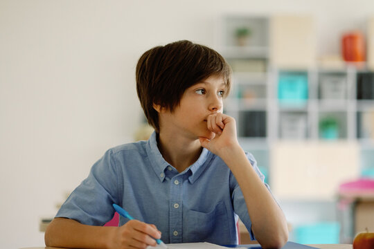 Learner thoughtful contemplate schoolwork handwriting studious idea