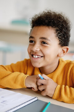 Cheerful funny pupil listening learning material