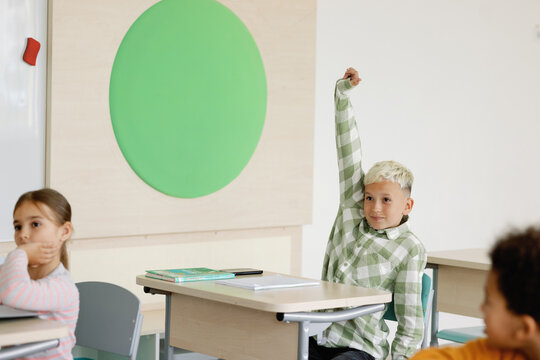 Hand up participating attentive active student elementary education