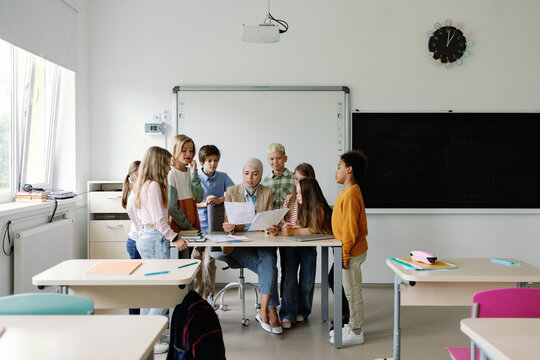 Schoolteacher paperwork feedback assessment auditorium education pupil
