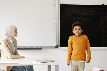Lesson pedagogue educating student timid newcomer schooltime classwork