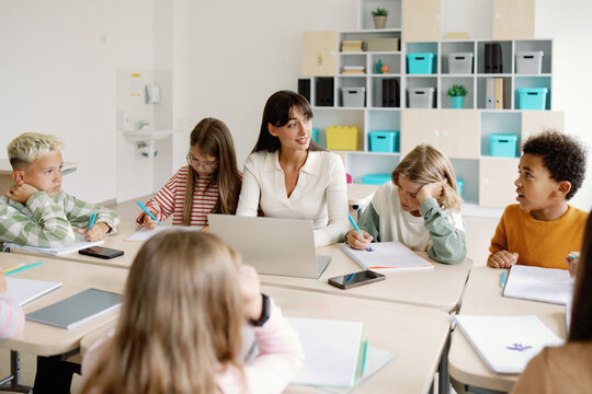 Schooling group project teacher explore material together - Powered by Adobe