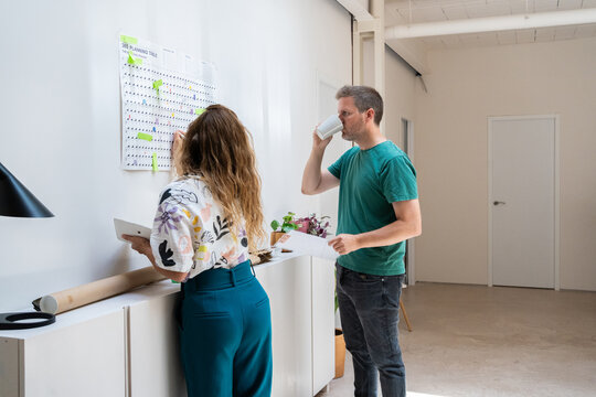 boss talking front a planner schedule at office 