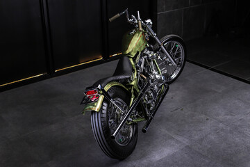 Chopper style motorcycle with green color hand painted full of chrome