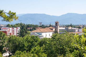 Landscape of the italian mountain and the city from the top of the park of the castle of Udine, Italy.