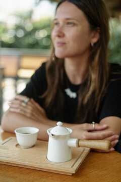 Woman drinking coffee at outdoor cafe