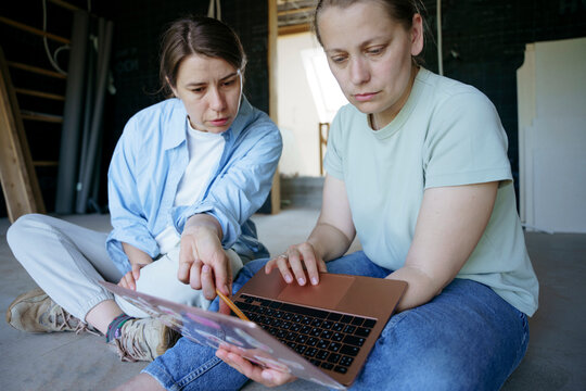 Women talk about the project in an unfinished house