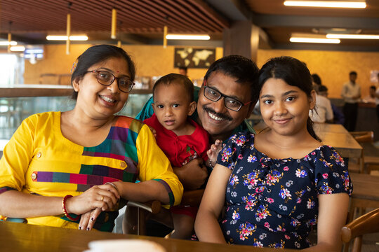 Indian family photograph sit inside a restaurant in holiday time
