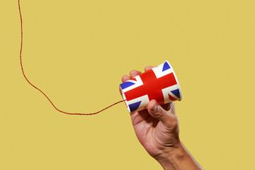 man holds an english string telephone