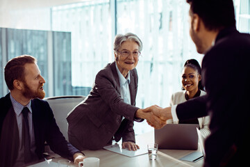 Senior woman in business meeting with diverse colleagues
