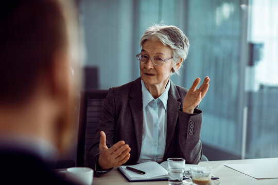 Senior woman in business meeting with diverse colleagues