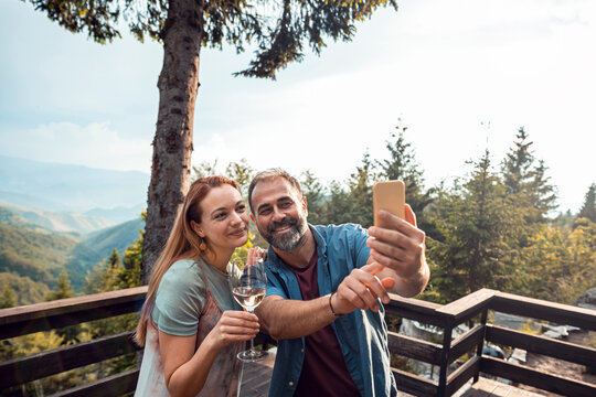 Happy couple taking selfie on cabin deck
