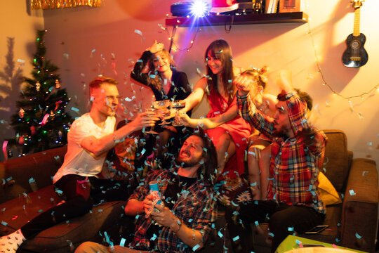 Moment of blowing up a confetti firecracker at home party