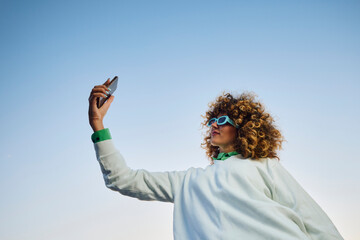 Woman takes a selfie in a clear sky