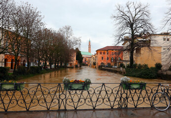 Flowerpots on the FURO Bridge and under the swollen RETRONE River during the flood in the city of...