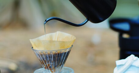 A coffee filter is being poured into a glass