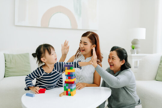 Asian family spending time together on holiday in living room