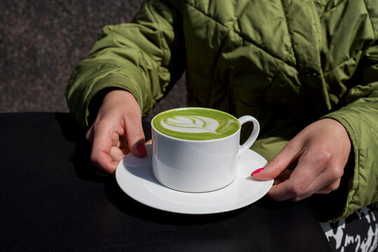 Anonymous woman having matcha latte